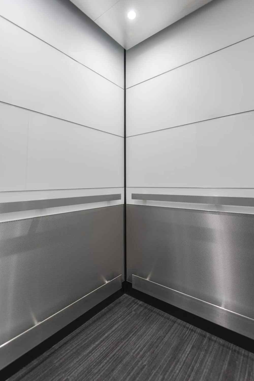 Boston Series elevator cab interior with stainless crash bumper rail